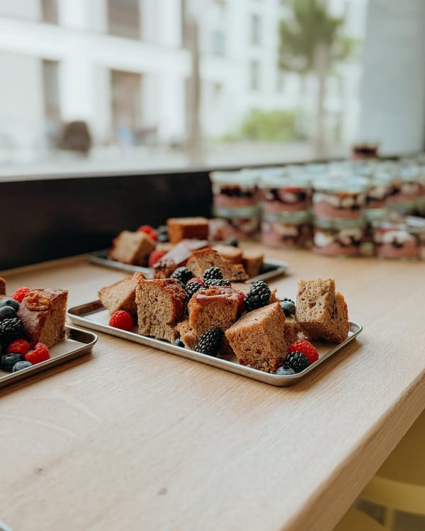 Kuchenstücke mit frischen Beeren auf einem Tablett am Fenster im mela